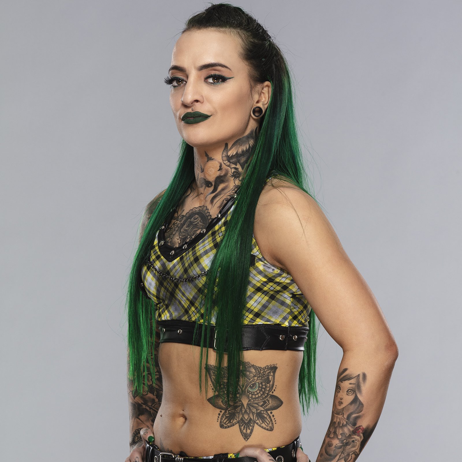 Ruby Soho tattoos: left forearm harlequin and side-abdomen owl