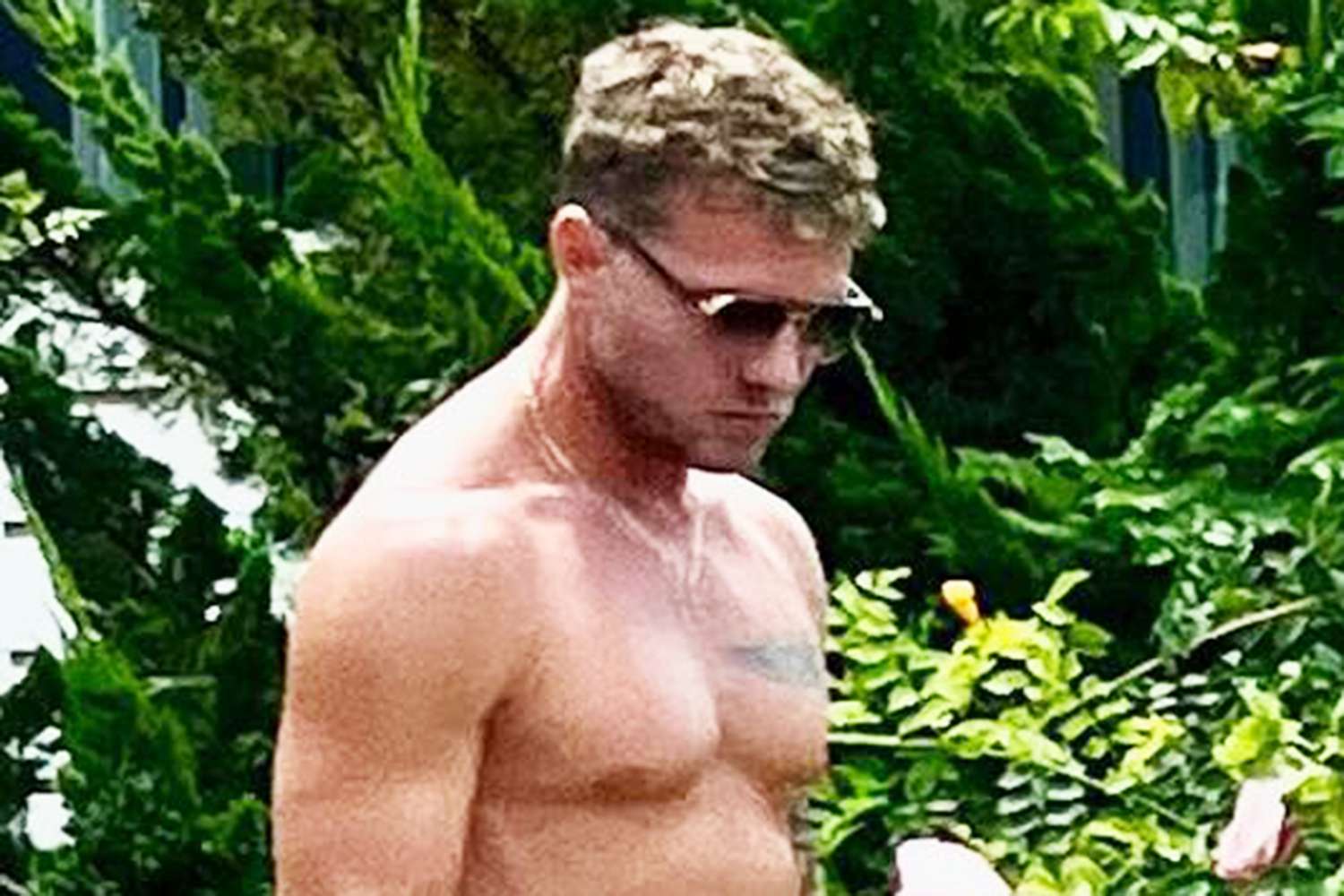 Ryan Phillippe tattoos: A separate shirtless People portrait showing the chest and arm placement in a natural setting