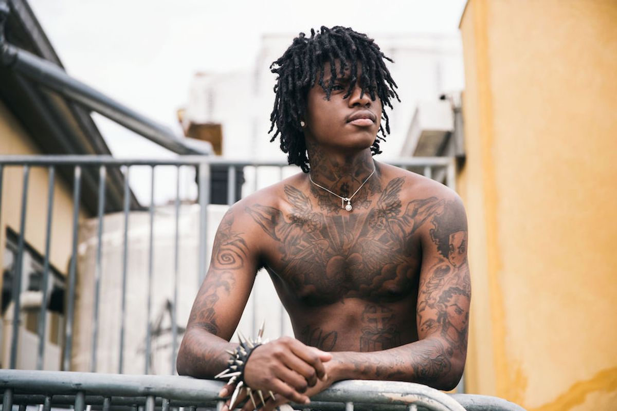 SahBabii tattoos: high-resolution shirtless balcony portrait showing the chest, shoulders, neck and arms