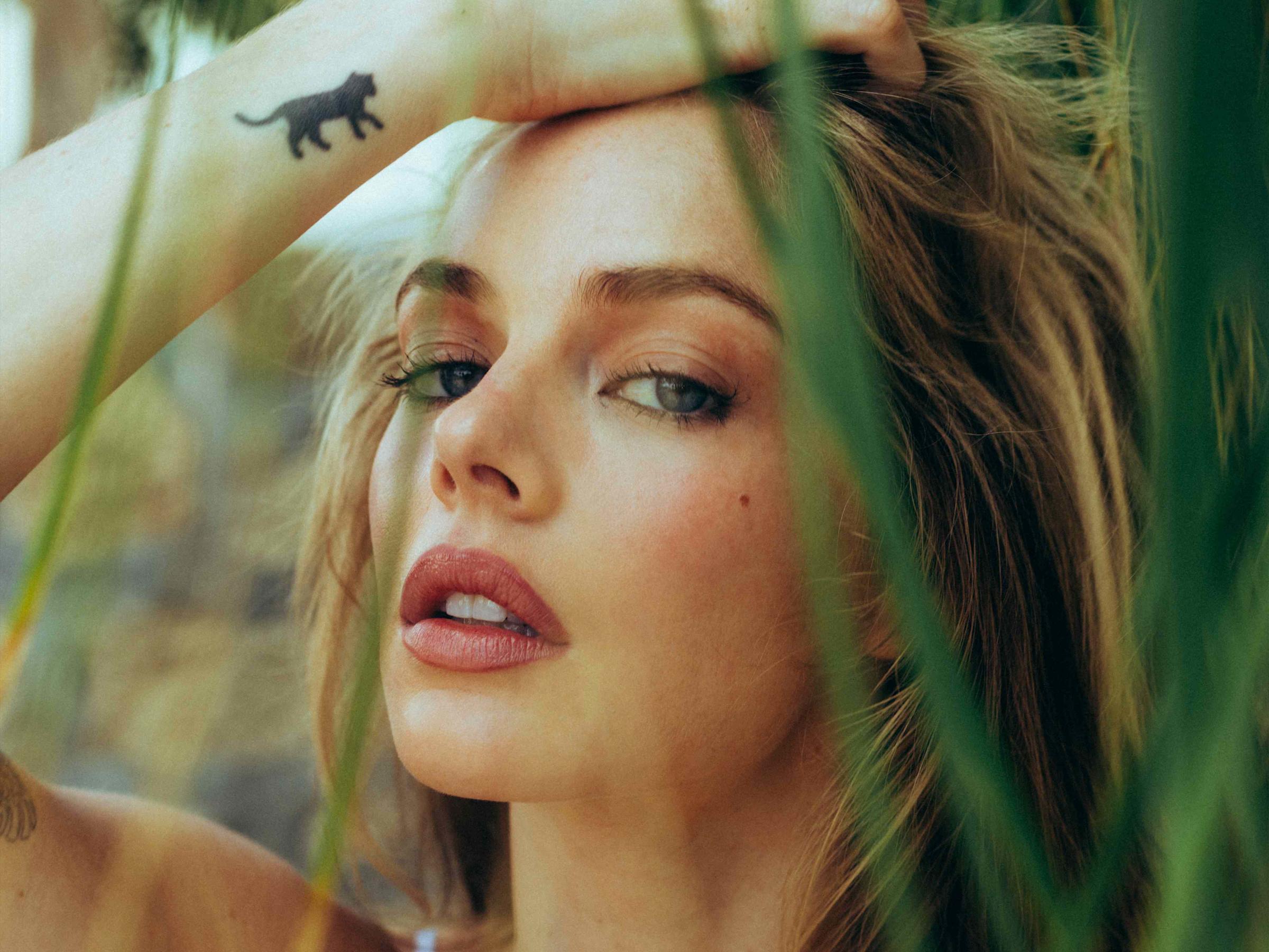 Samara Weaving black animal tattoo Samara Weaving tattoos: Genuine tattoo photograph showing the black animal silhouette on the forearm
