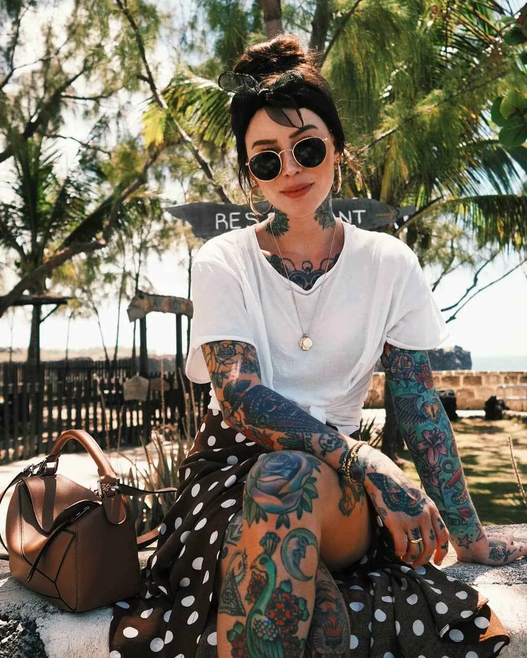 Sammi Jefcoate tattoos: The peacock, flowers and blue rose on her leg