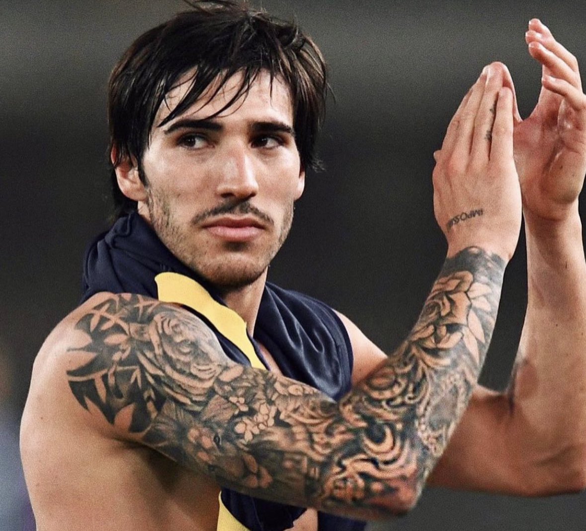 Sandro Tonali tattoos: arm and hand tattoos in a distinct AC Milan post-match photograph