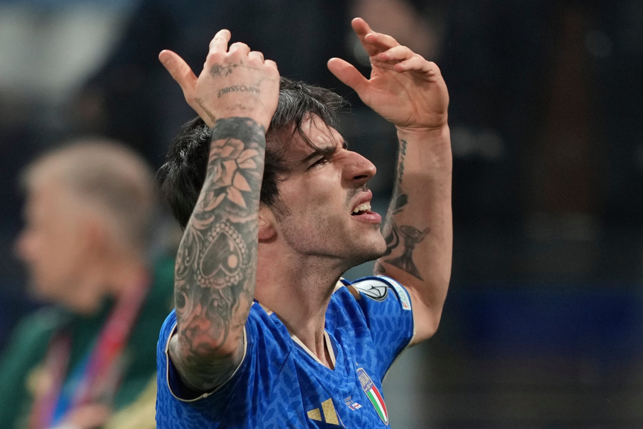 Sandro Tonali tattoos: arm sleeves and visible floral designs in an Italy match photograph