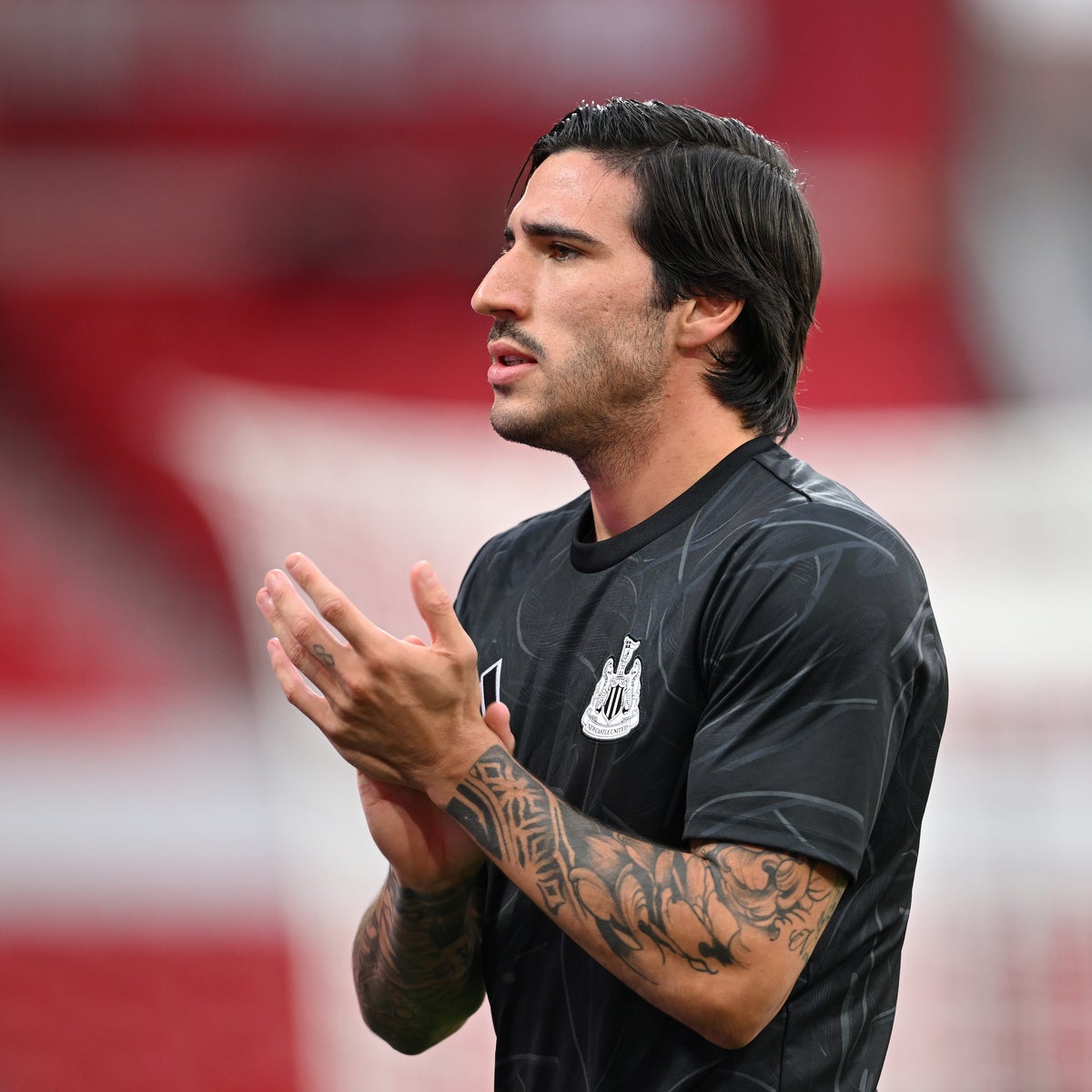 Sandro Tonali tattoos: forearm sleeve tattoos visible in a Newcastle return warm-up photograph
