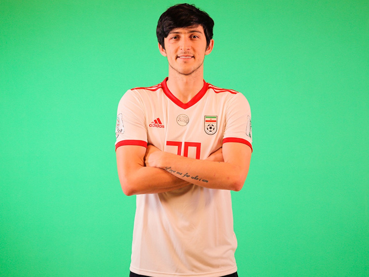 Sardar Azmoun tattoos: distinct Iran portrait showing the forearm lettering and its lengthwise placement
