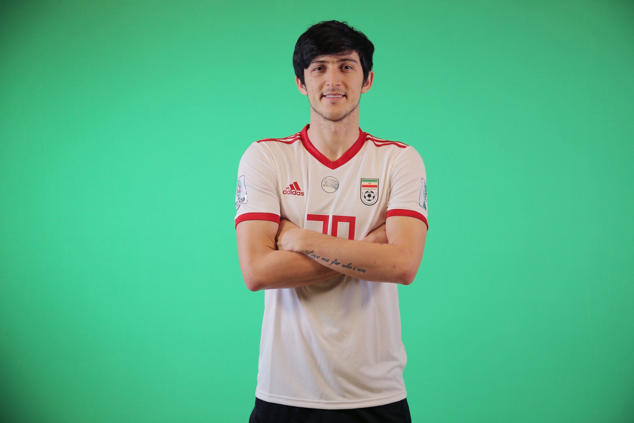 Sardar Azmoun tattoos: high-resolution national-team view of the forearm phrase