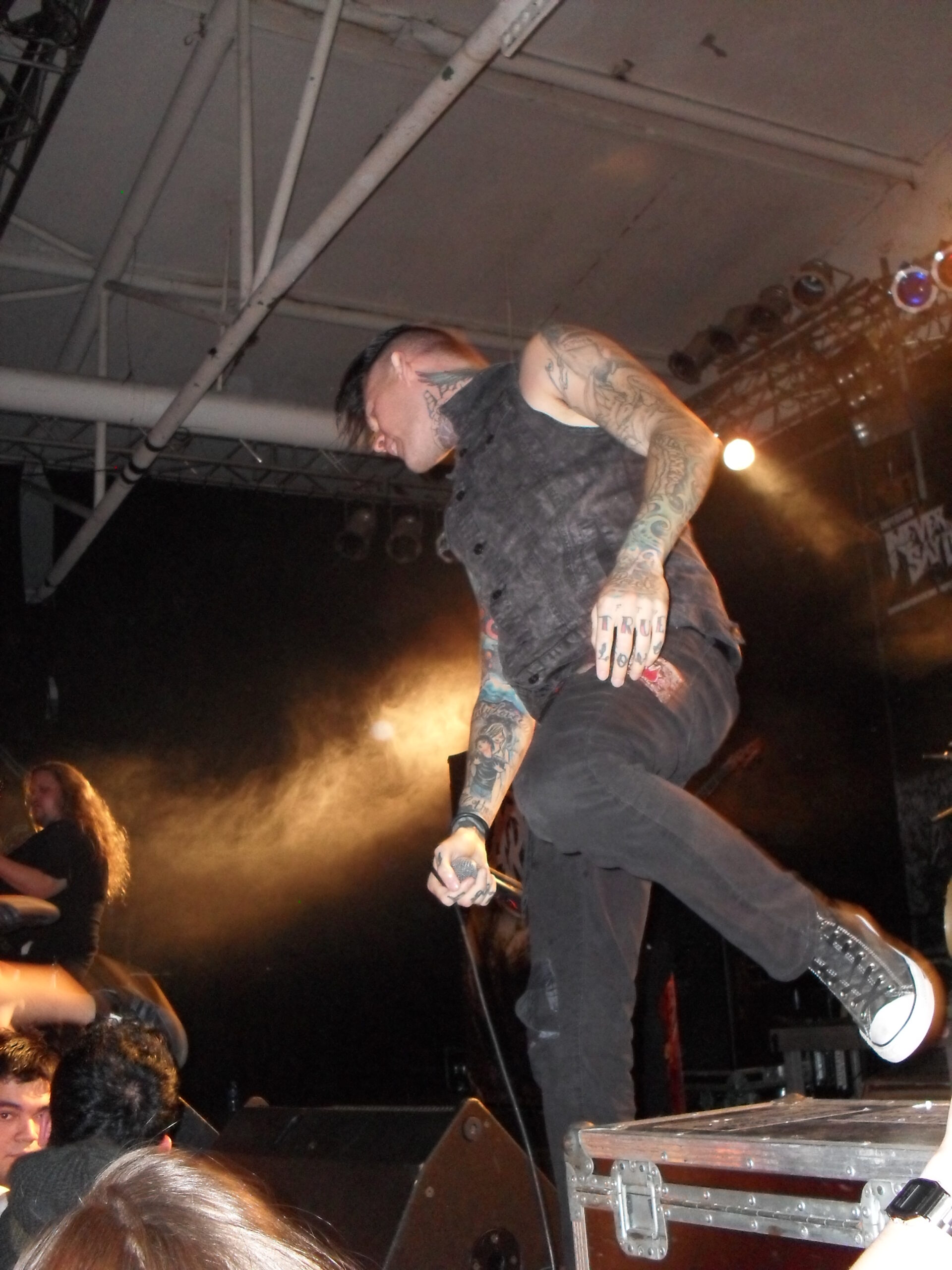 Scott Lewis showing his hand, neck, and arm tattoos