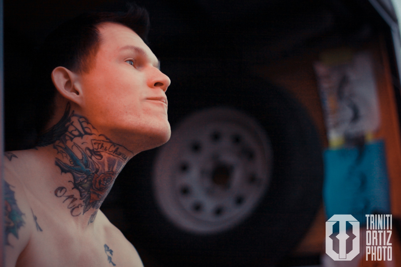 Scott Lewis showing his neck and chest tattoos