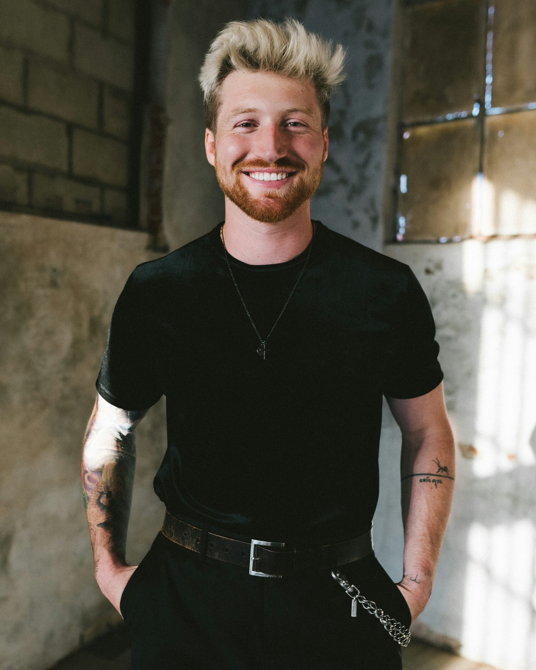 Scotty Sire tattoos: Tattoo evidence: separate high-resolution editorial portrait showing the tattooed arm and smaller wrist pieces.