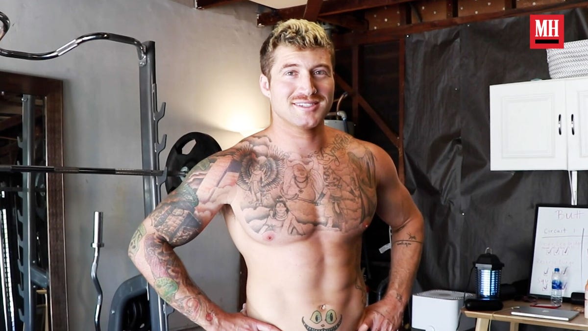 Scotty Sire tattoos: Tattoo evidence: shirtless Men’s Health portrait showing the chest, sleeves and the cat-face cover-up on the abdomen.