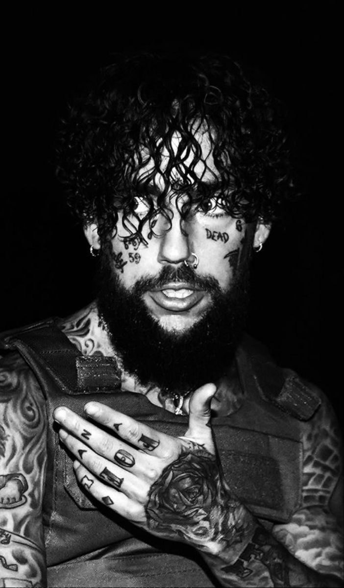 Scrim tattoos: black-and-white face, finger and hand tattoos in a clear close portrait