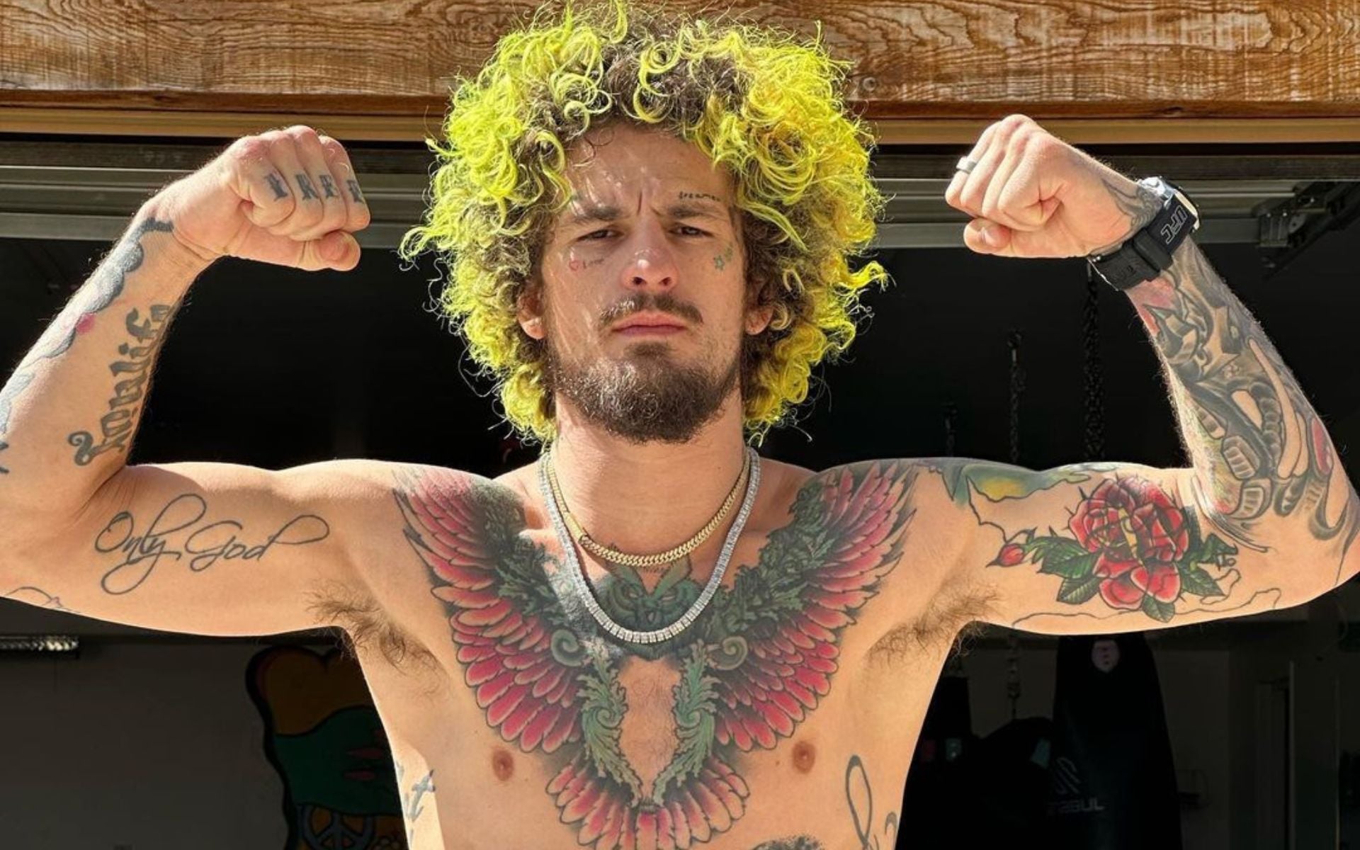 Sean O'Malley showing his Only God forearm tattoo