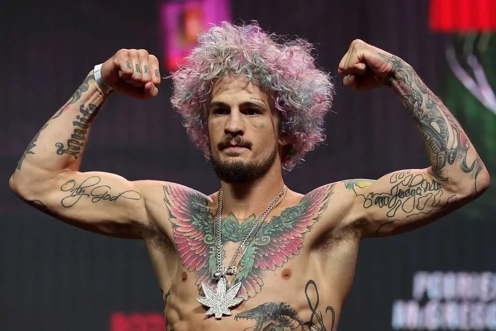 Sean O'Malley showing his arm and finger tattoos