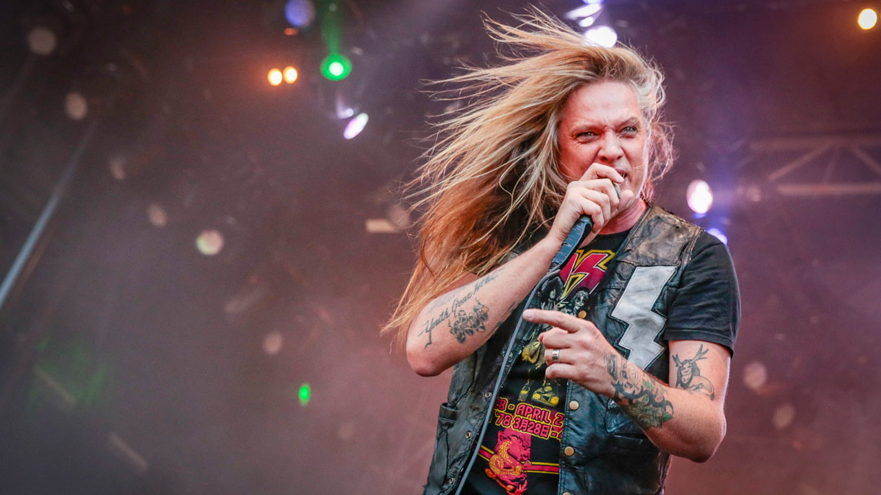 Sebastian Bach tattooed arms in close live performance