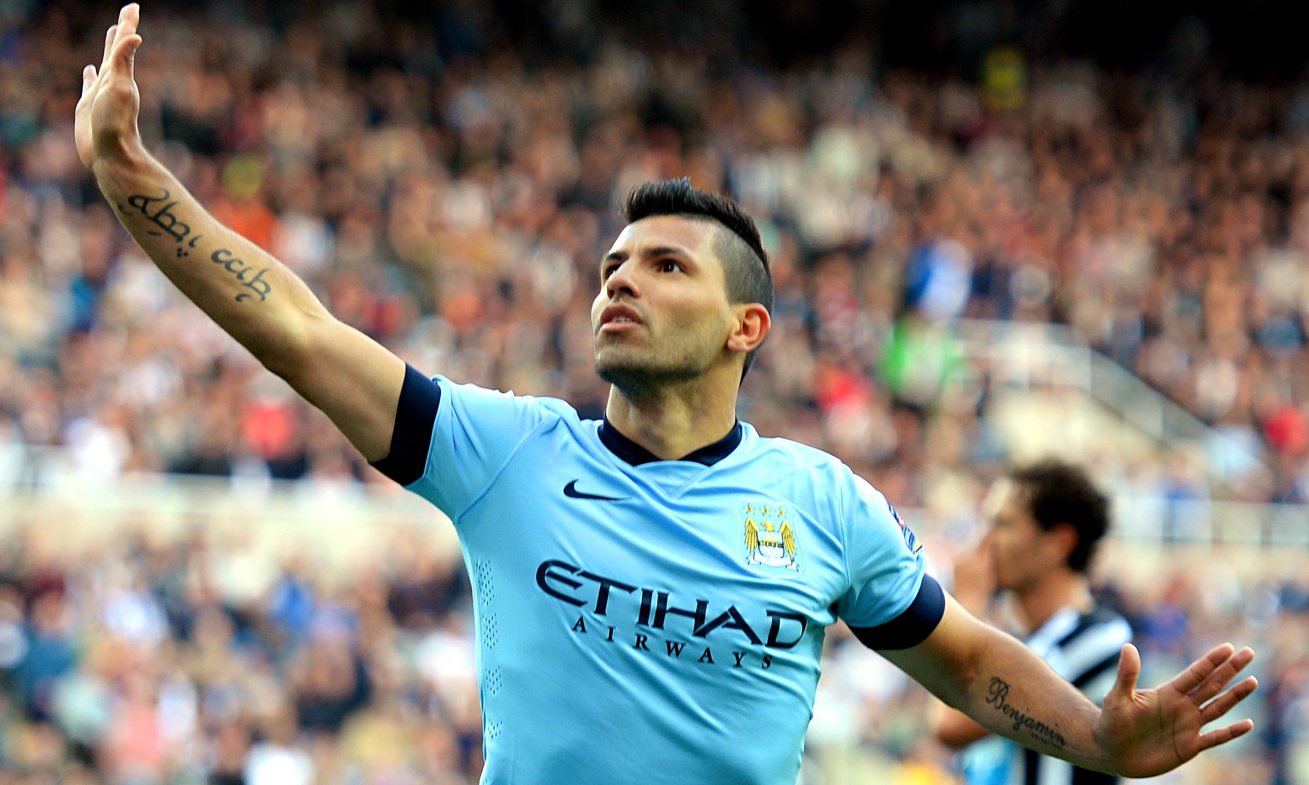 Sergio Aguero raising his tattooed arm after a Manchester City match