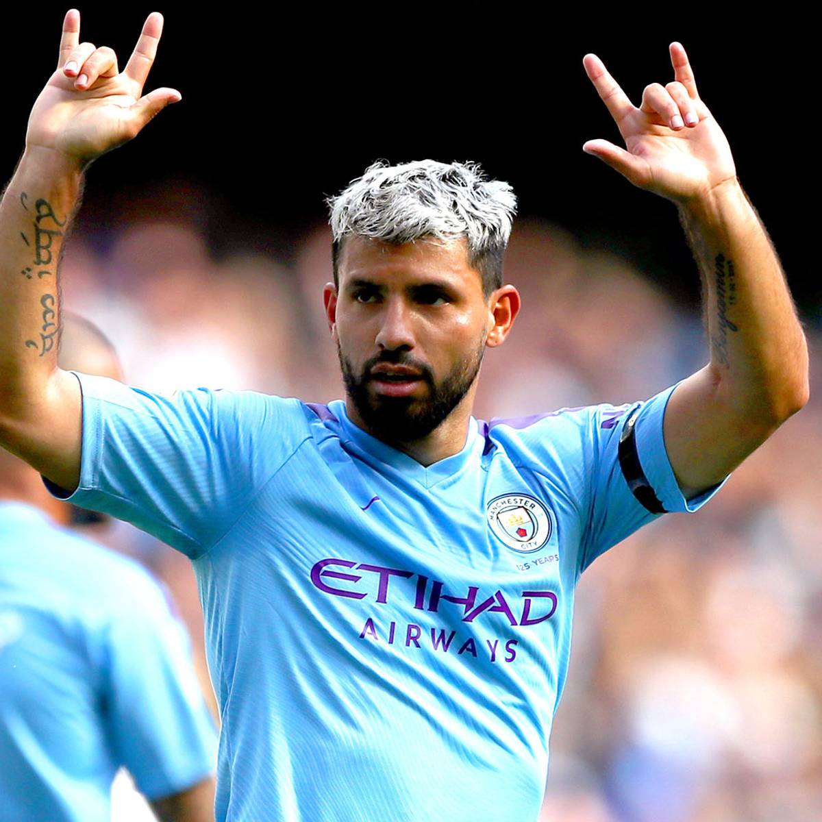 Sergio Aguero with both forearm tattoos visible while celebrating for Manchester City