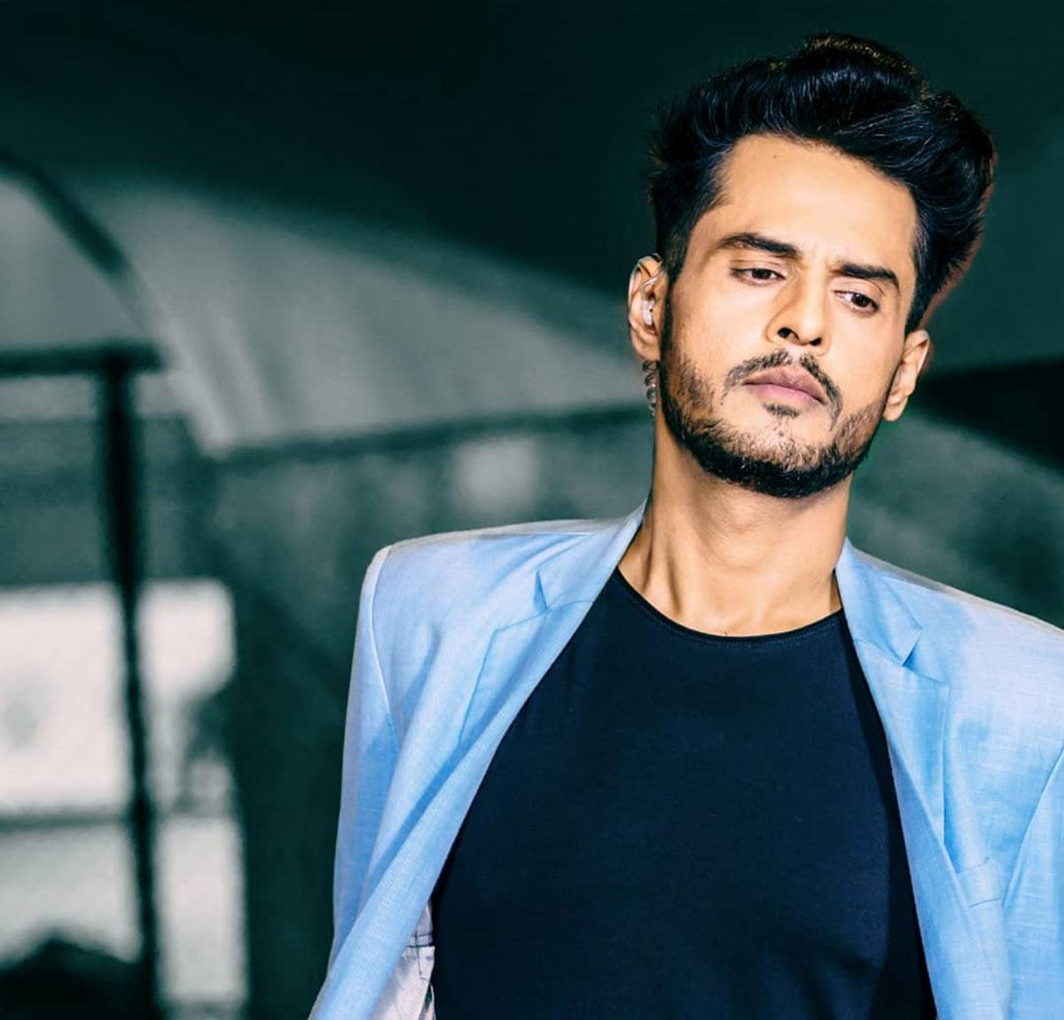Shardul Pandit in a pale blue jacket Shardul Pandit in a contextual photograph: inline; not tattoo evidence
