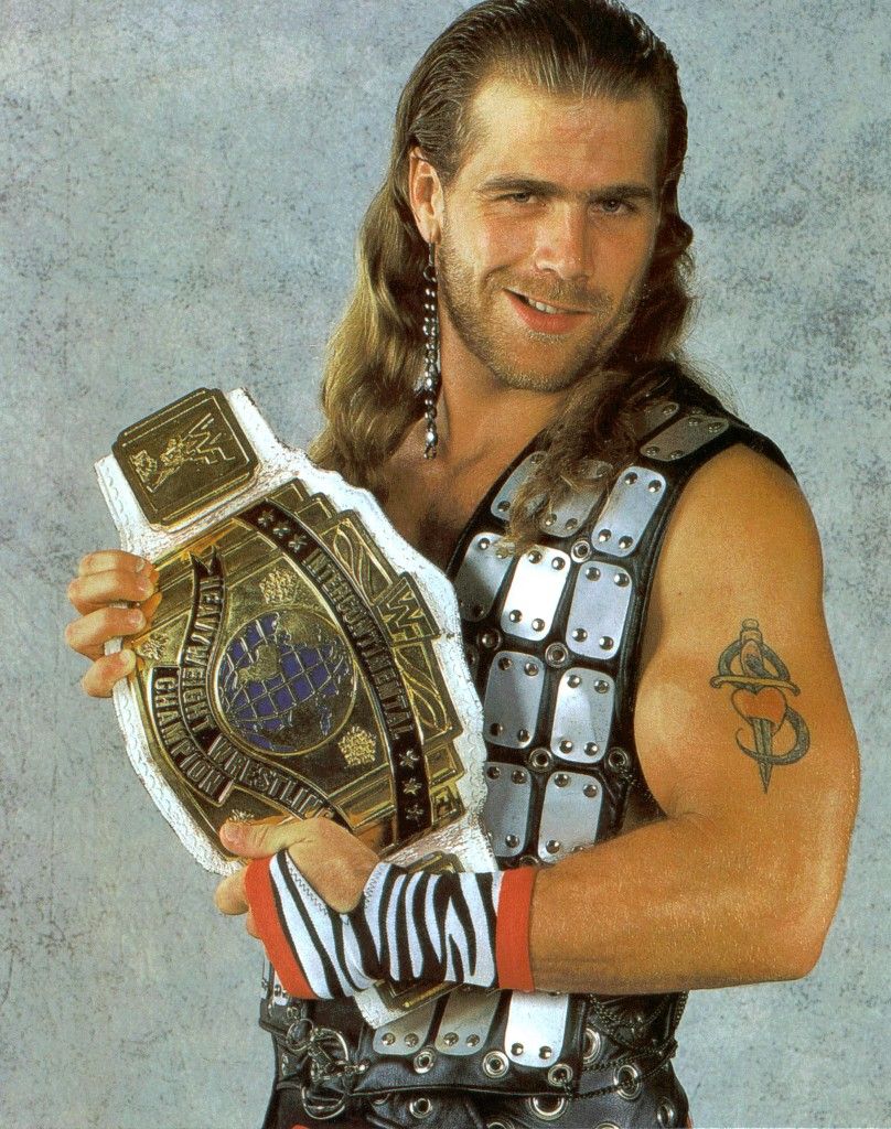 Shawn Michaels championship-era arm tattoo beside a title belt