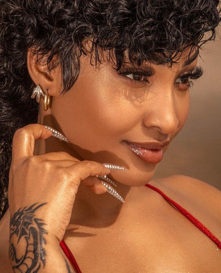 Shenseea dragon forearm tattoo performance photo Shenseea tattoos: Shenseea's dragon tattoo in performance photos