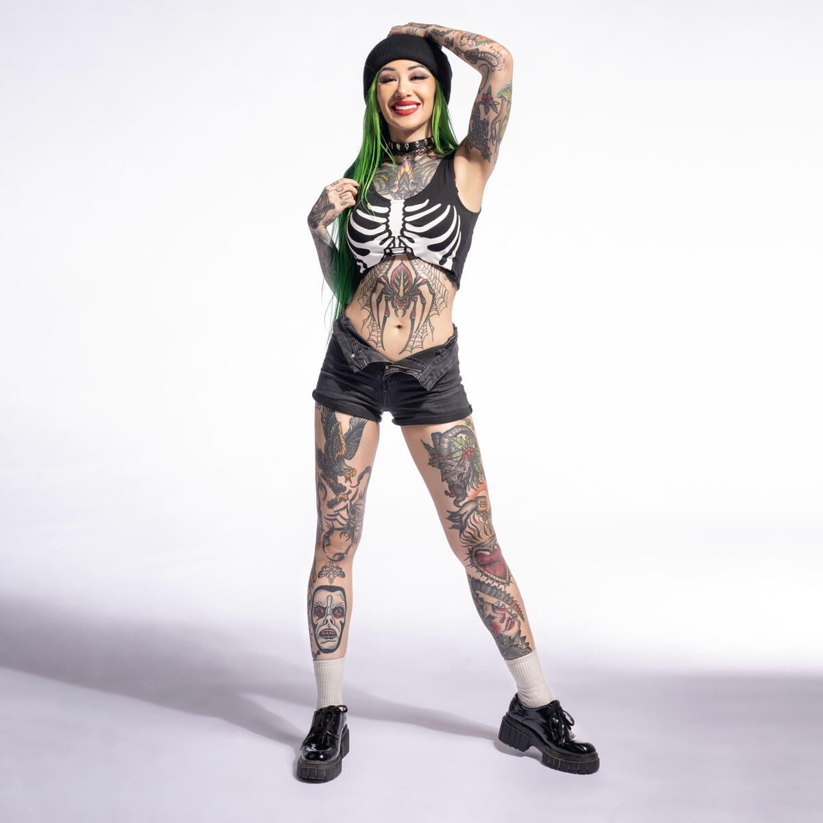 Shotzi full body showing sleeve and leg tattoos