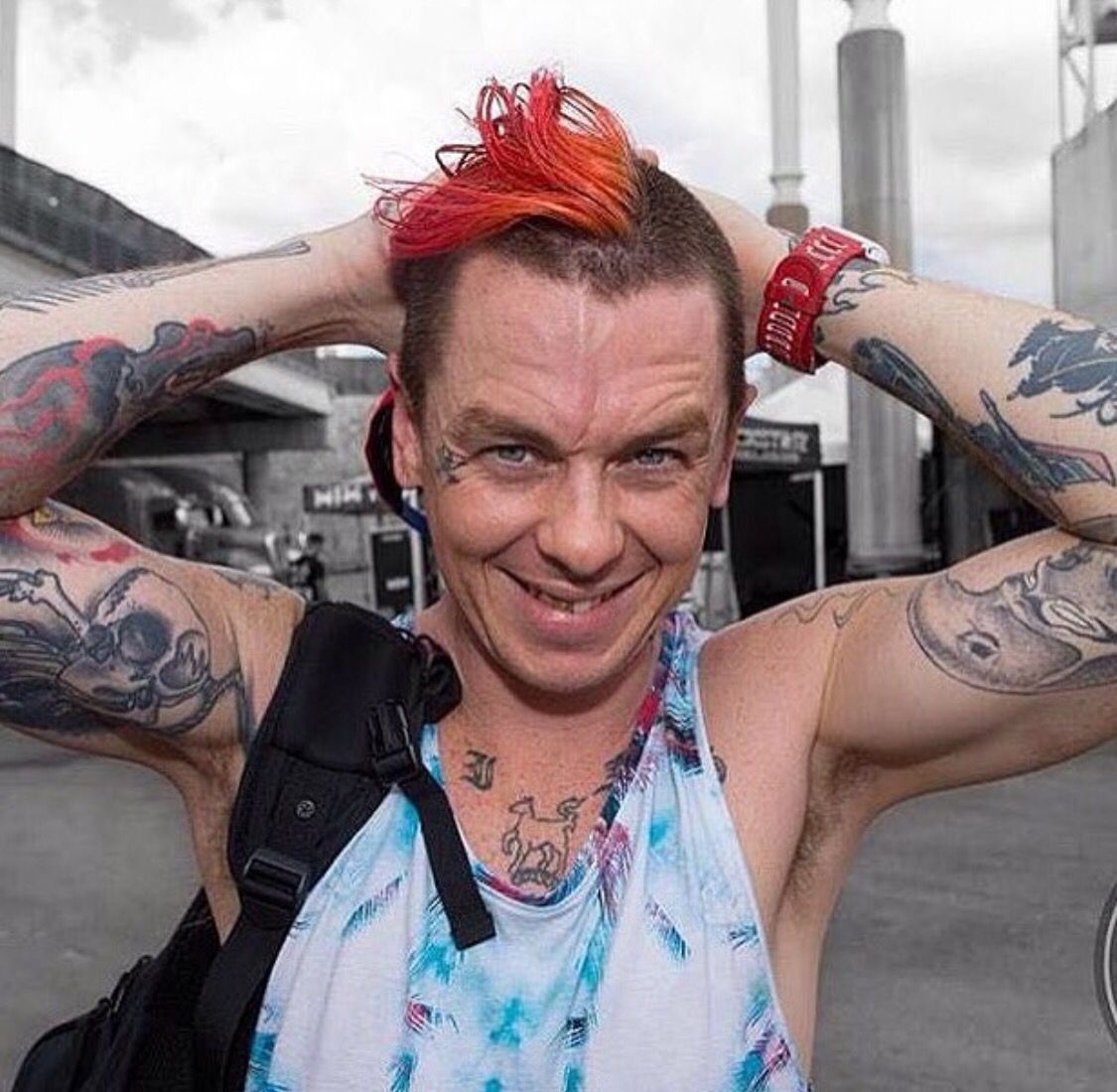 Sid Wilson tattoos: high-resolution portrait showing colorful arm and chest tattoos from a different setting