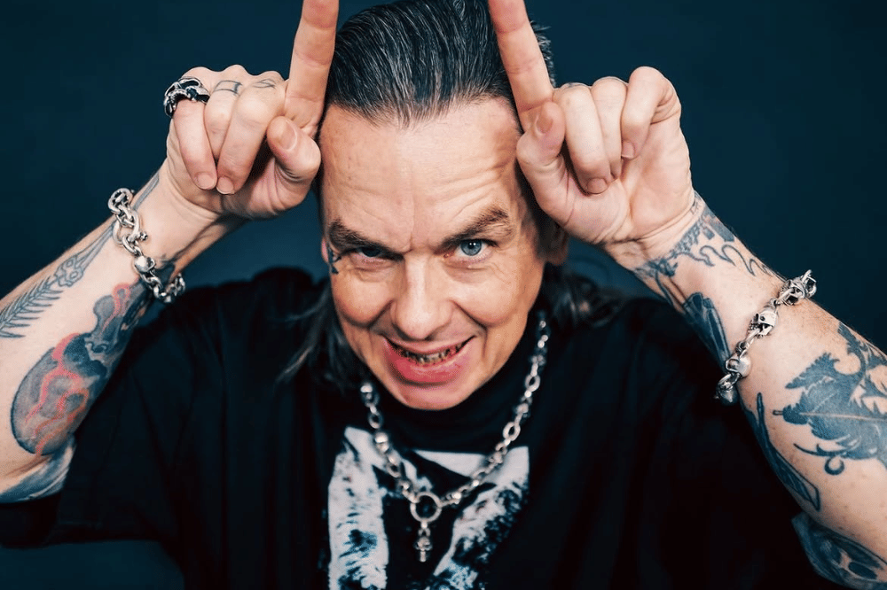 Sid Wilson tattoos: high-resolution portrait showing the tattooed hands, arms and neck in a separate pose