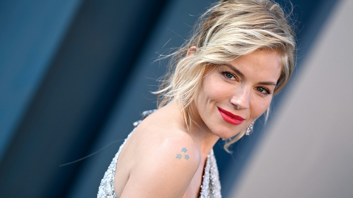 Sienna Miller contextual photograph Sienna Miller in a contextual photograph: sparkling red-carpet context; not tattoo evidence