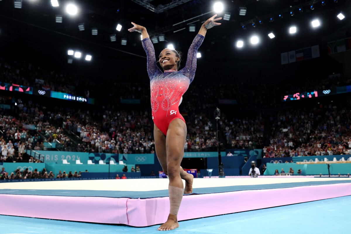 Simone Biles contextual floor-routine celebration; does not show tattoo evidence Simone Biles in a contextual photograph: contextual floor-routine celebration; does not show tattoo evidence; not tattoo evidence