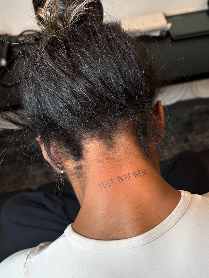 Simone Biles back-of-neck MADE IN HEAVEN lettering visible from behind Simone Biles tattoos: back-of-neck MADE IN HEAVEN lettering visible from behind