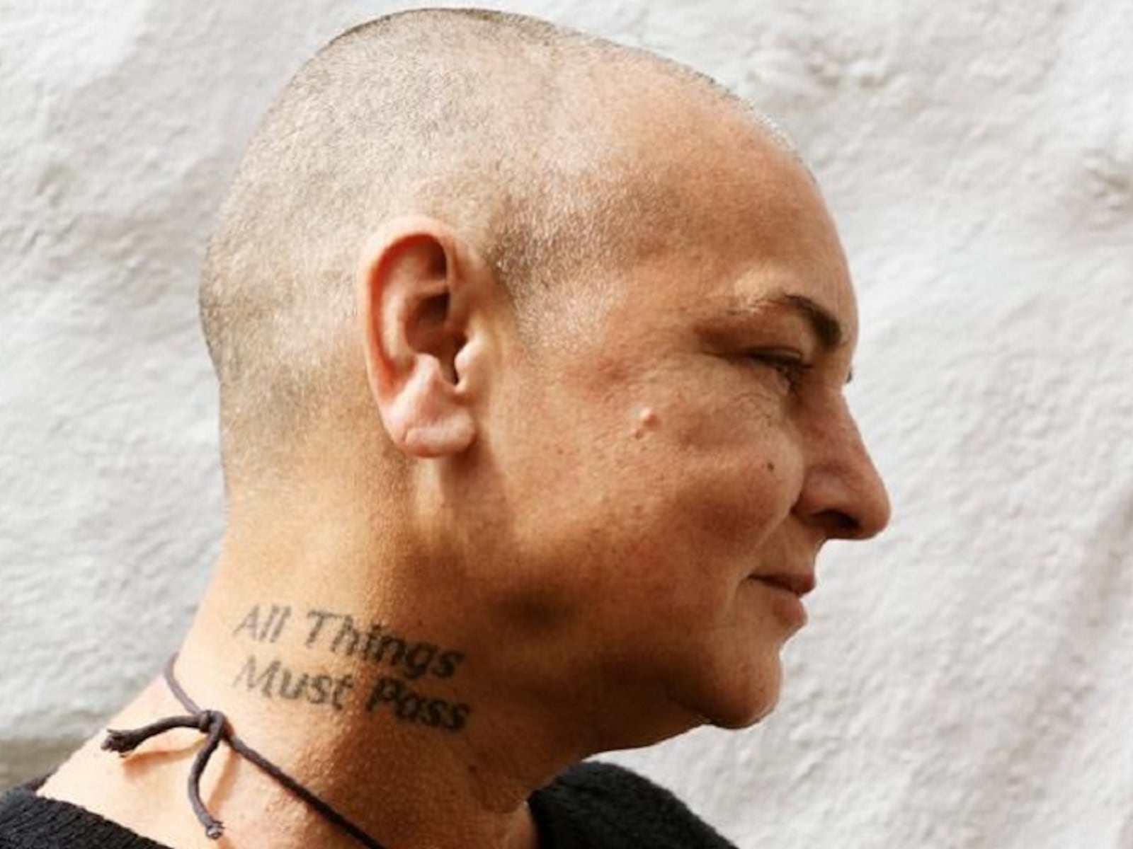 Sinéad O'Connor tattoos: Sinéad O'Connor All Things Must Pass neck tattoo, selected because the named tattoo area is clearly visible in a distinct high-resolution photograph
