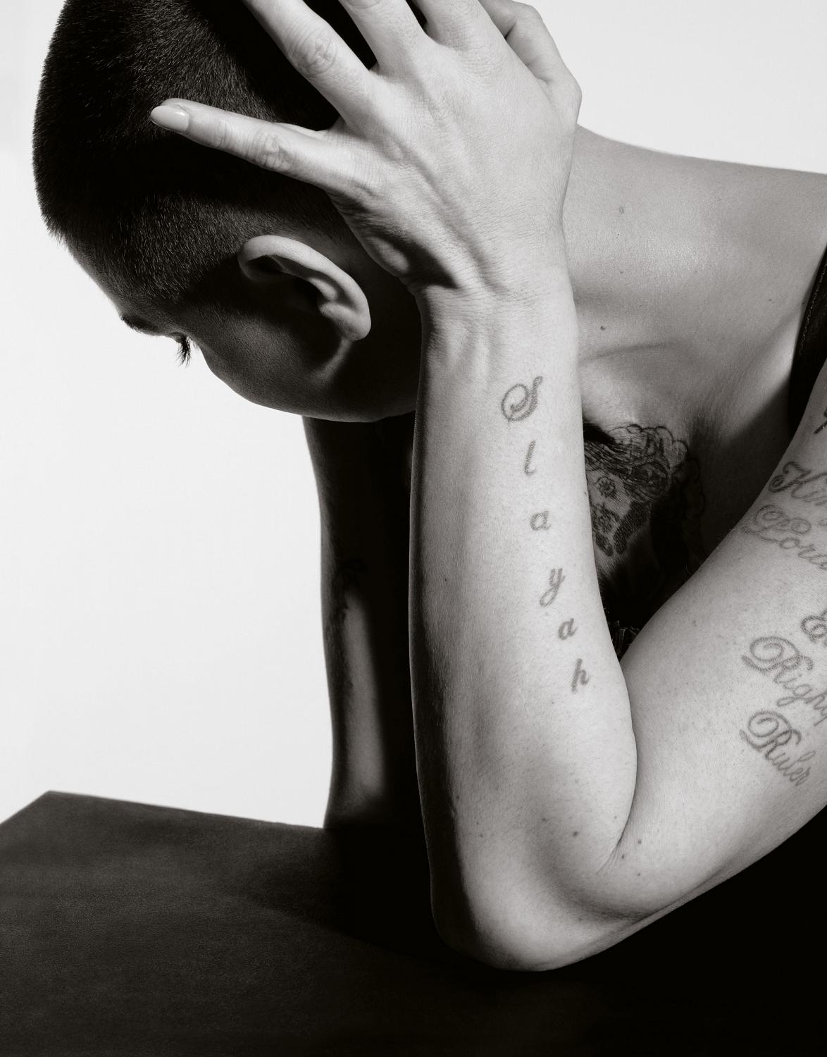 Sinéad O'Connor tattoos: Sinéad O'Connor forearm script tattoos, selected because the named tattoo area is clearly visible in a distinct high-resolution photograph