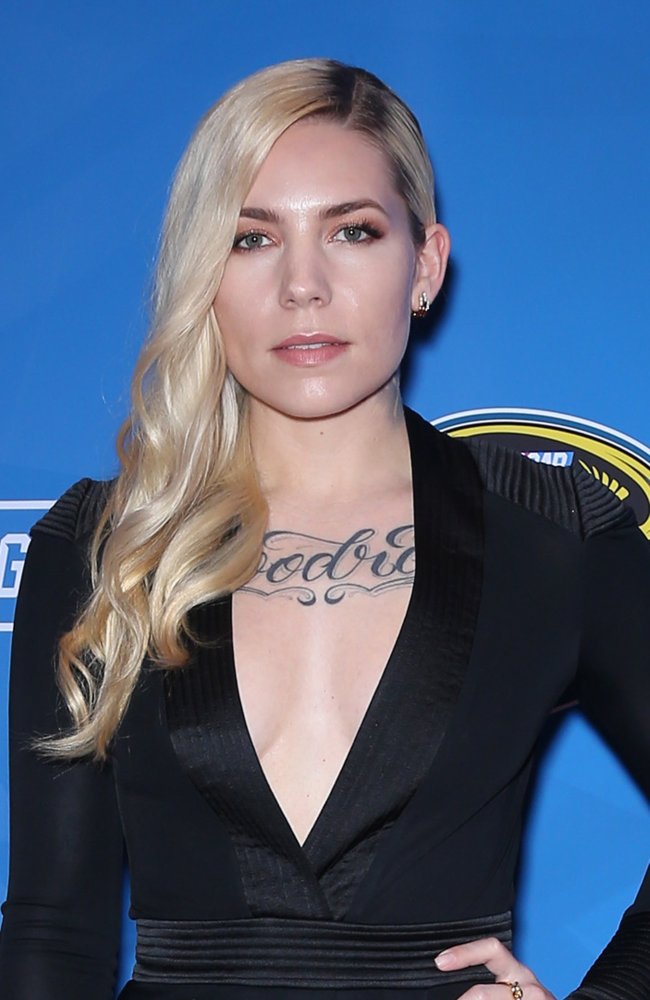 Skylar Grey tattoos: Separate red-carpet chest-script photograph showing the Woodrat lettering at a different angle