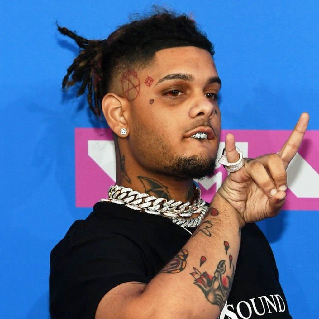 Smokepurpp tattoos: high-resolution event portrait showing the face, neck and upper chest tattoo placement