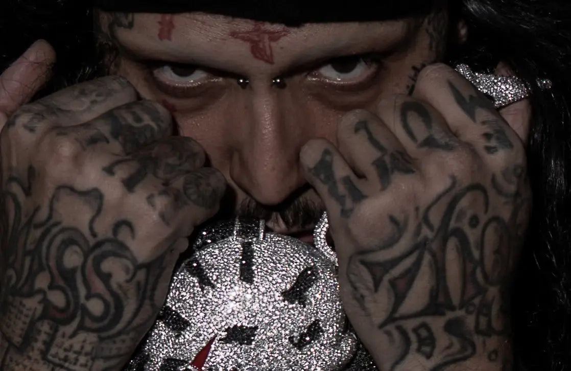 SosMula tattooed hands and pendant