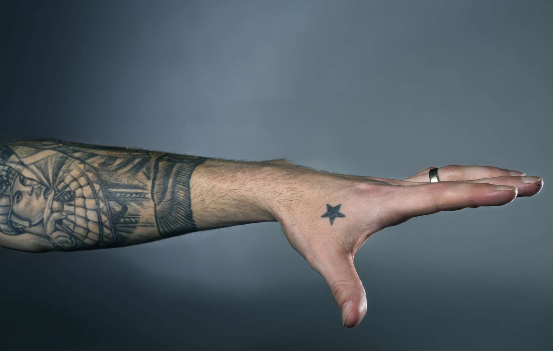 Stefan Frei tattoos: close view of the dark championship star between the left thumb and index finger