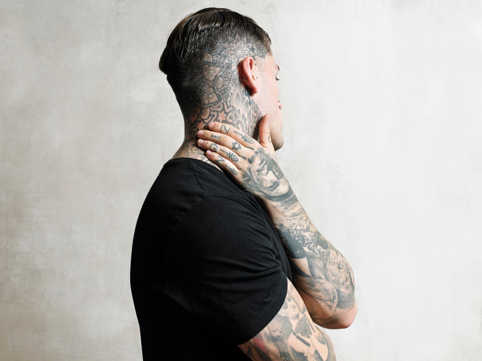 Stephen James tattoos: Shaved-head geometric patterns, hand portrait and separate finger symbols