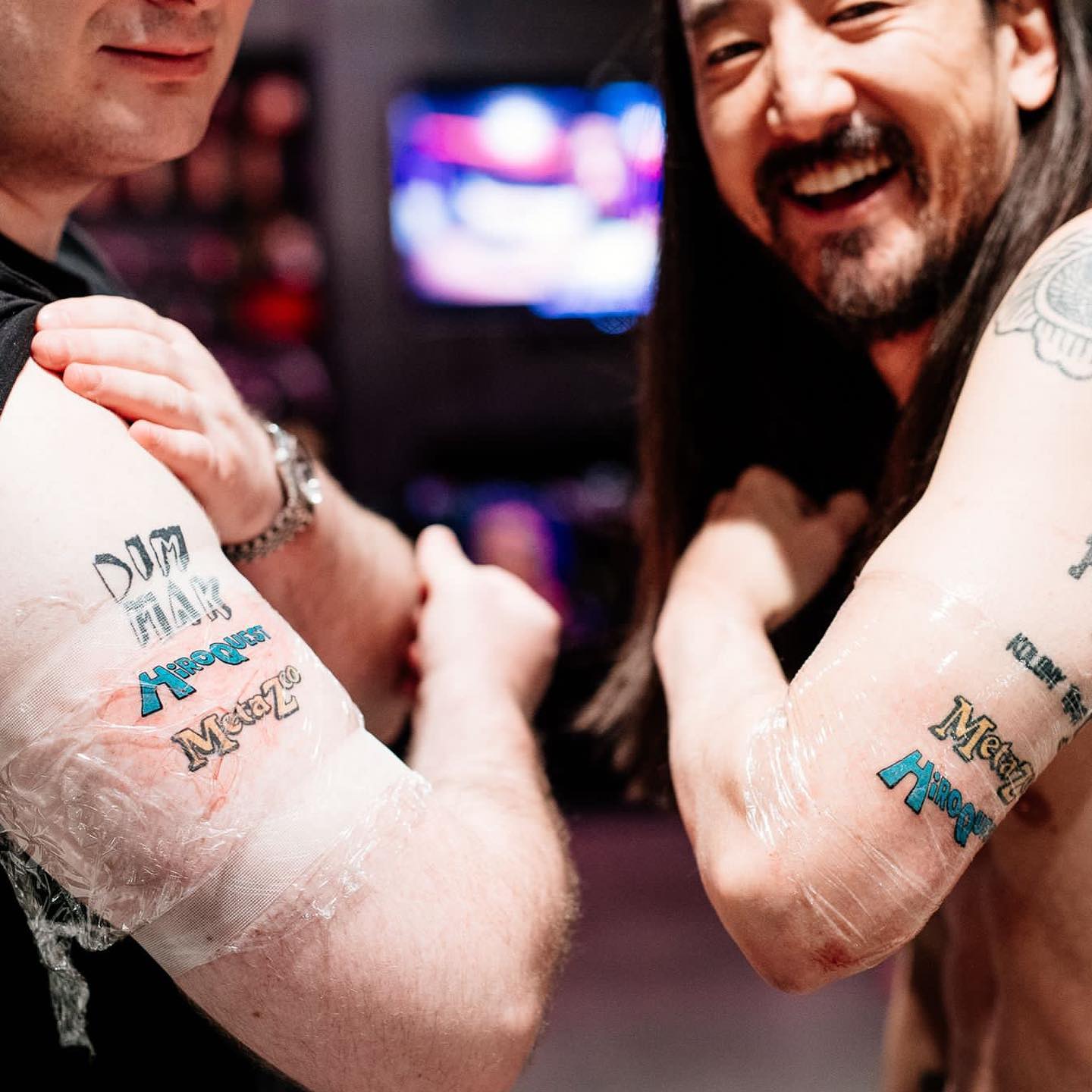 Steve Aoki Metazoo and HiroQuest arm tattoos
