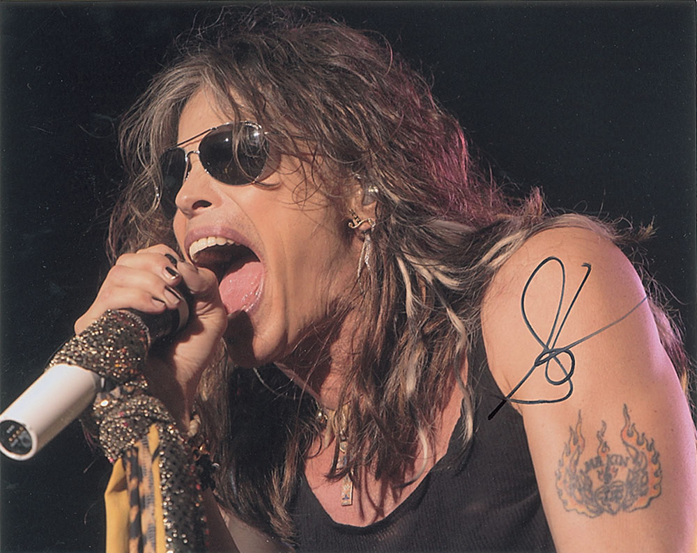 Steven Tyler’s flaming winged-heart tattoo seen clearly on stage