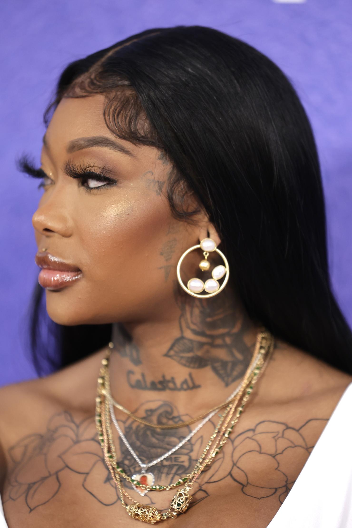 Summer Walker tattoos: Summer Walker close-up showing the Celestial neck lettering and floral chest tattoo
