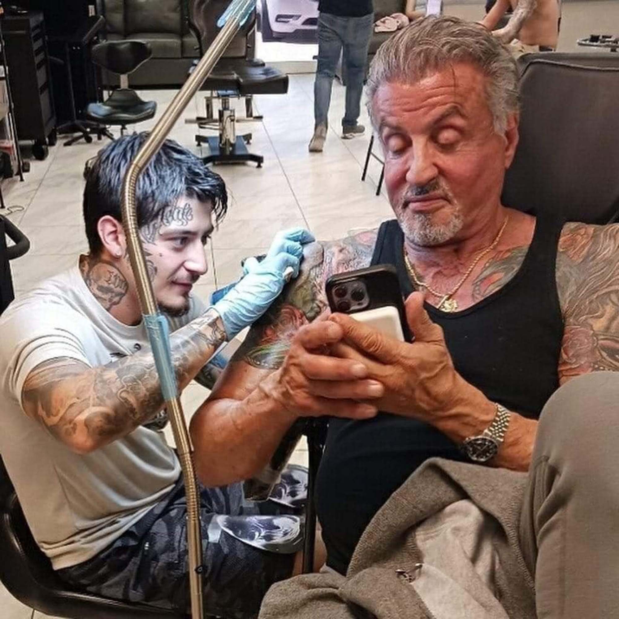 Sylvester Stallone tattoo session showing his arm tattoos