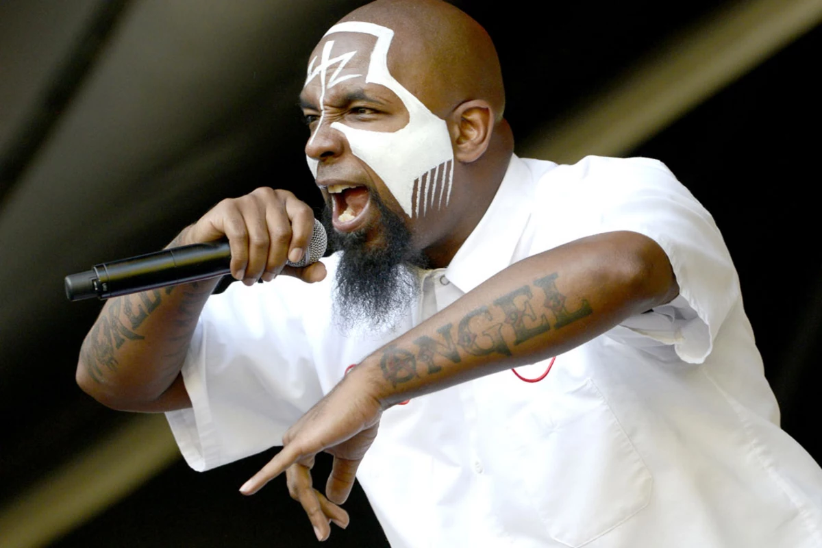 Tech N9ne tattoos: performance image showing both tattooed forearms beside the SACRIFICE chest area