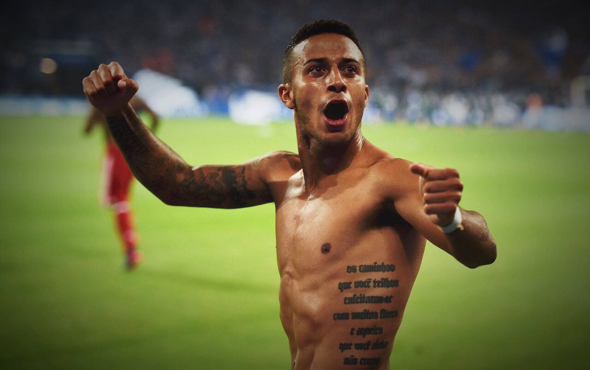 Thiago Alcántara tattoos: visible torso lettering and right-arm tattoo work in a shirtless match celebration