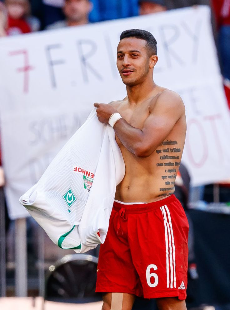 Thiago Alcántara tattoos: separate match photograph showing torso script and arm tattoos