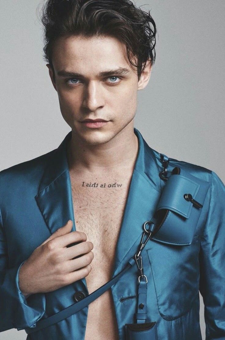 Thomas Doherty tattoos: Thomas Doherty portrait with the upper-chest text tattoo visible