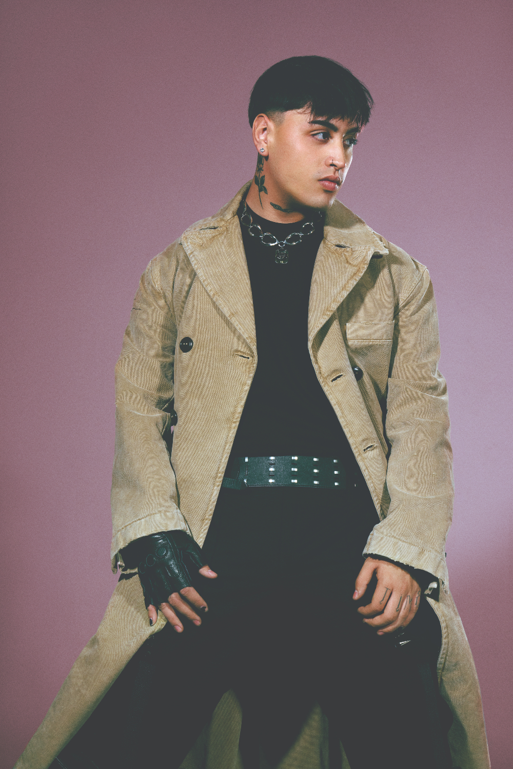 Tiago PZK in a contextual photograph: Contextual full-length styling in a tan long coat; not tattoo evidence