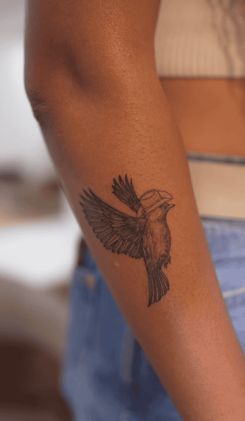 Tiera Kennedy tattoos: Close tattoo evidence for the blackbird, hat and wing linework