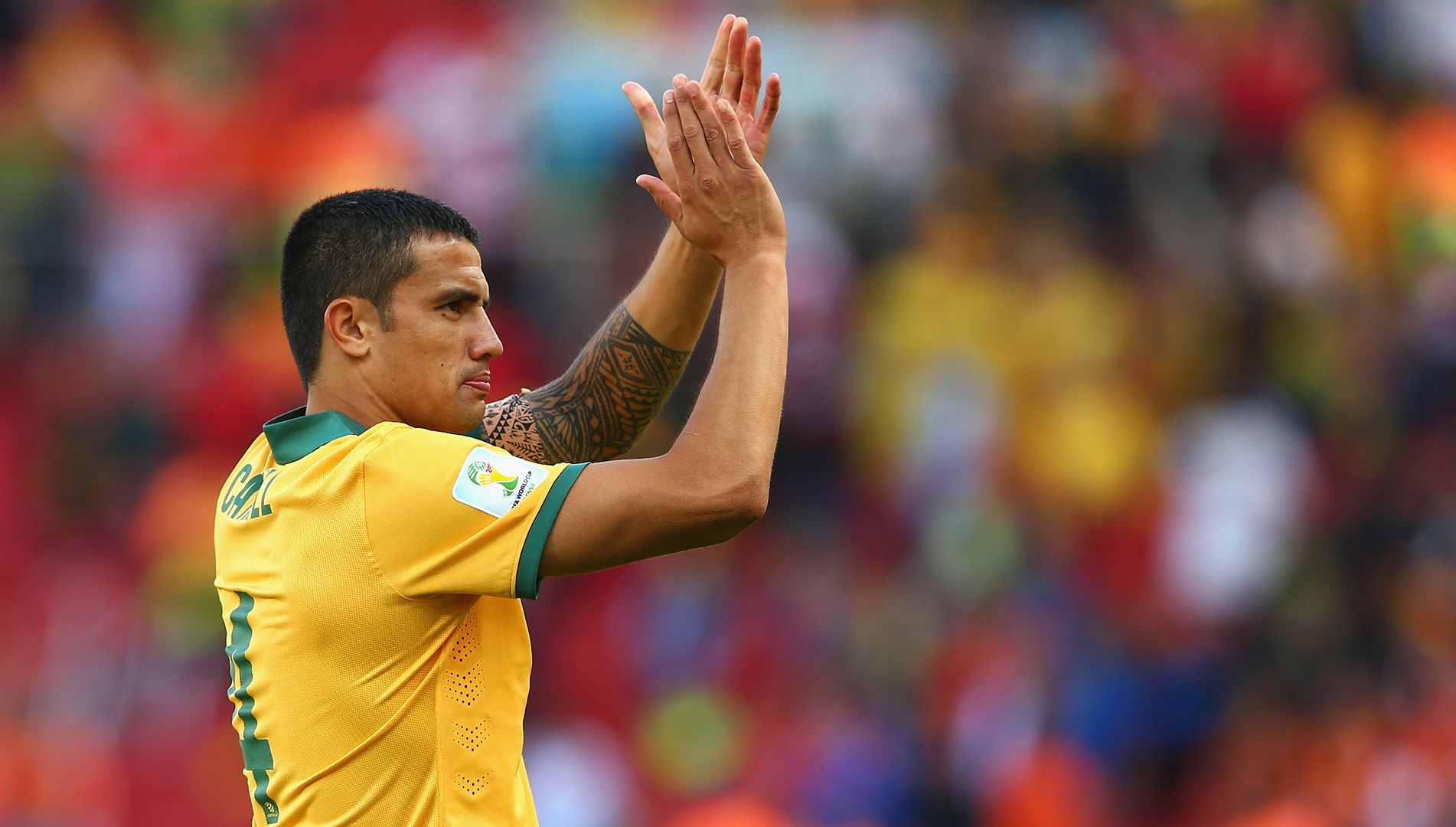 Tim Cahill Distinct yellow-kit applause photograph showing the geometric sleeve as Cahill acknowledges supporters Tim Cahill tattoos: Distinct yellow-kit applause photograph showing the geometric sleeve as Cahill acknowledges supporters