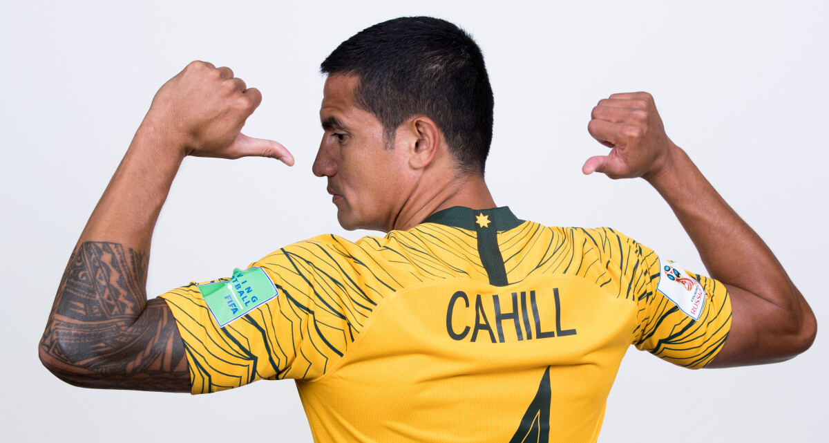 Tim Cahill left-arm tattoo in yellow Socceroos shirt Tim Cahill tattoos: yellow-shirt rear portrait showing his left-arm sleeve
