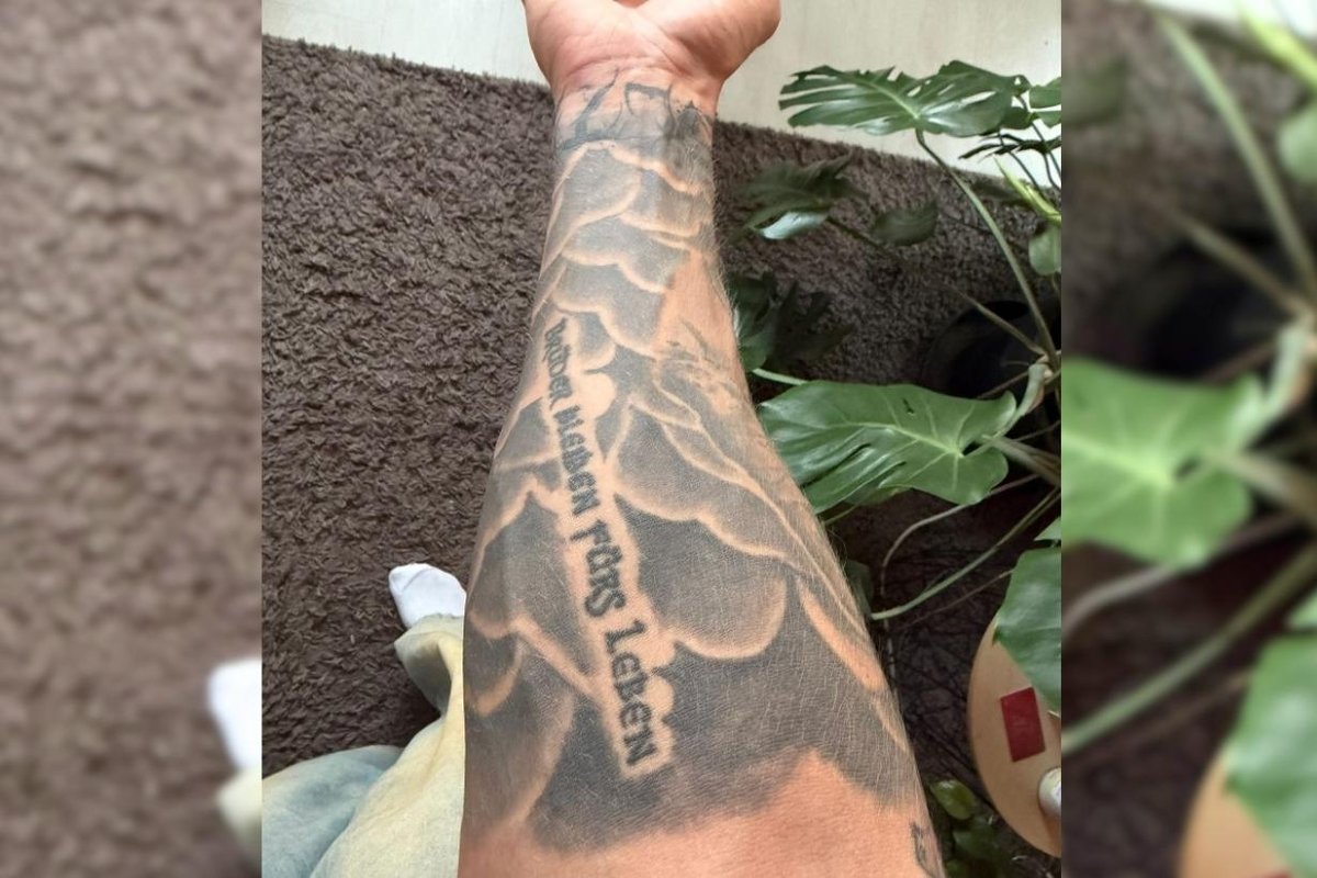 Tim Dolle Memorial lettering and symbols on the right forearm Tim Dolle tattoos: Memorial lettering and symbols on the right forearm