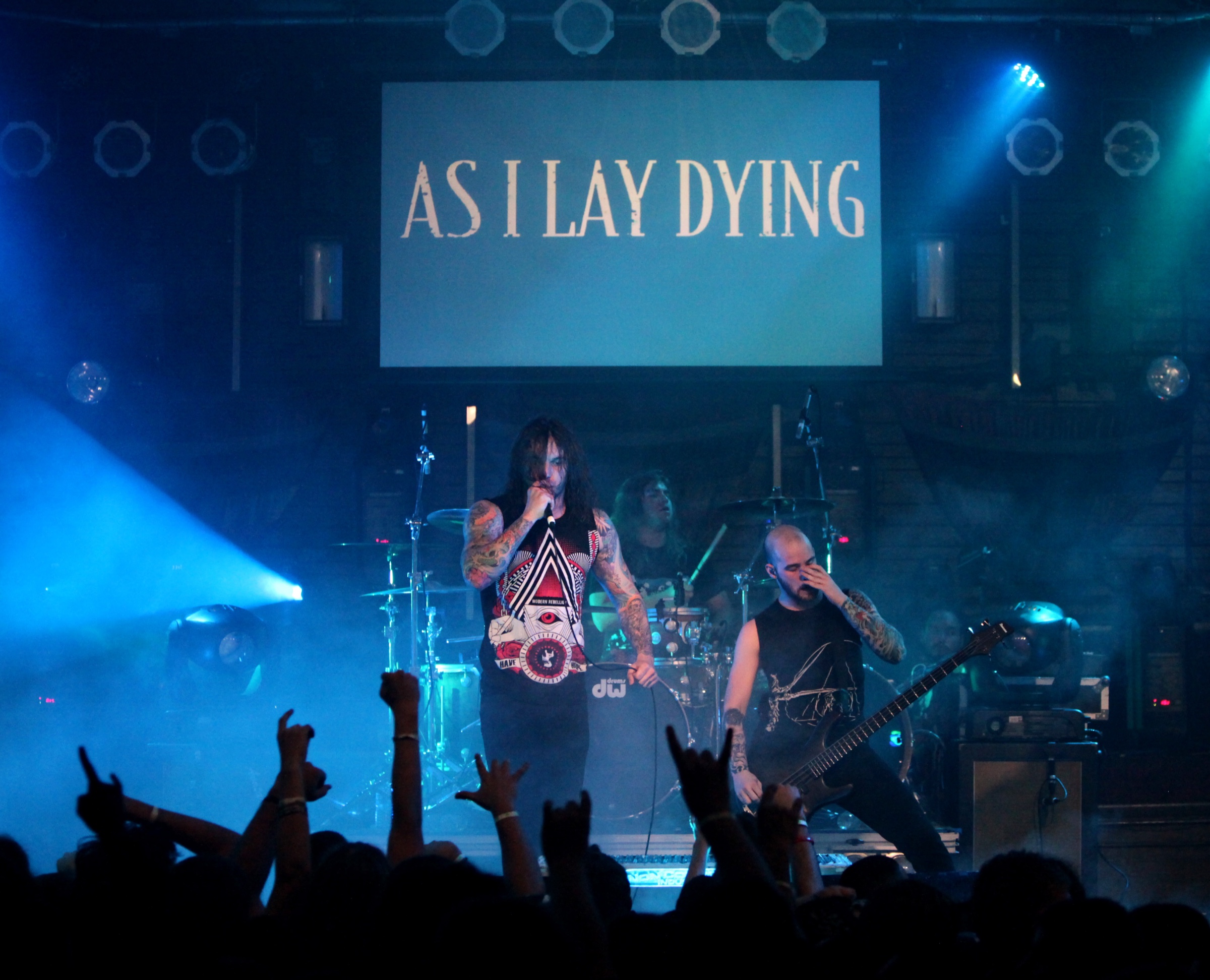 Tim Lambesis performing live with colorful arm tattoos visible